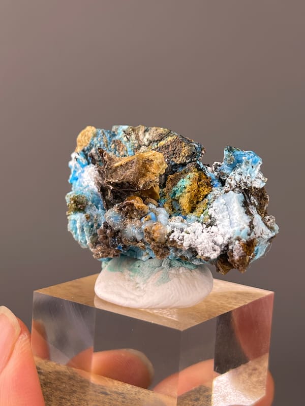 Gibbsite specimen from Qinglong, Guizhou, China, defined by pale blue fibrous material with white druse