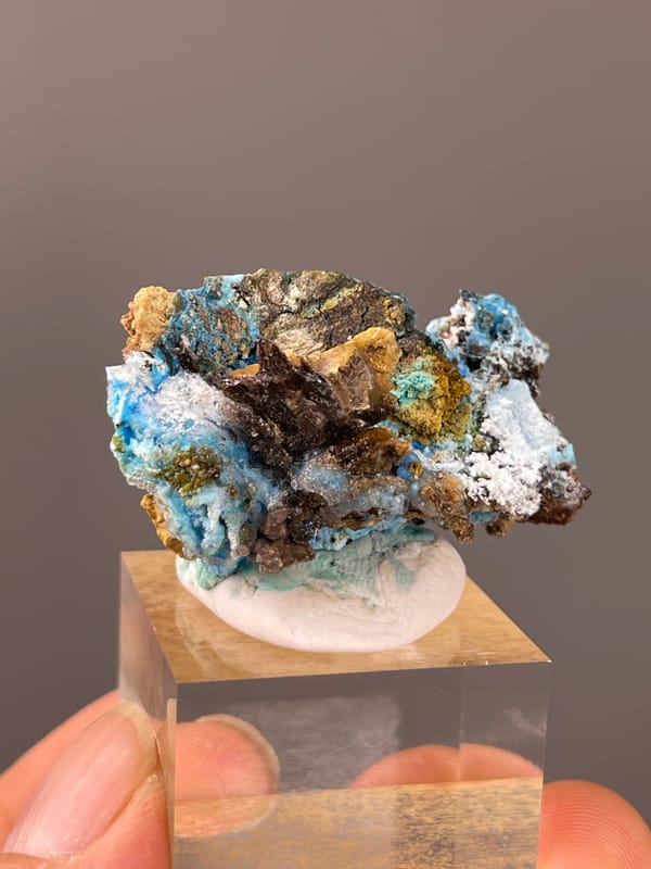 Gibbsite specimen from Qinglong, Guizhou, China presenting pale blue fibrous material with white druse