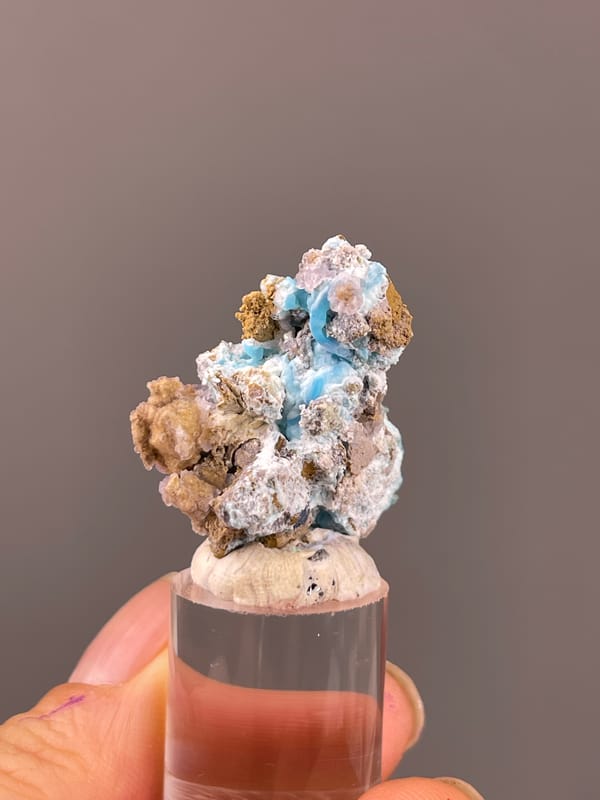 Gibbsite specimen from Qinglong, Guizhou, China displaying blue-pink botryoidal material with yellow matrix