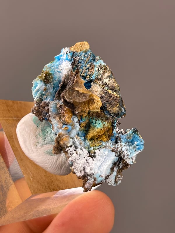 Gibbsite specimen from Qinglong, Guizhou, China displaying pale blue fibrous material with white druse