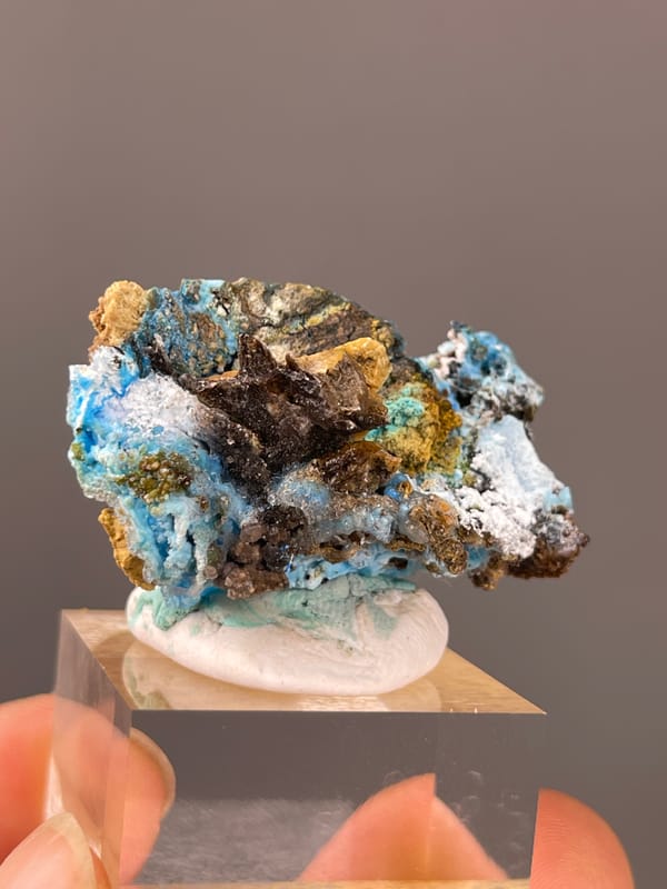Gibbsite specimen from Qinglong, Guizhou, China, characterized by pale blue fibrous material with white druse