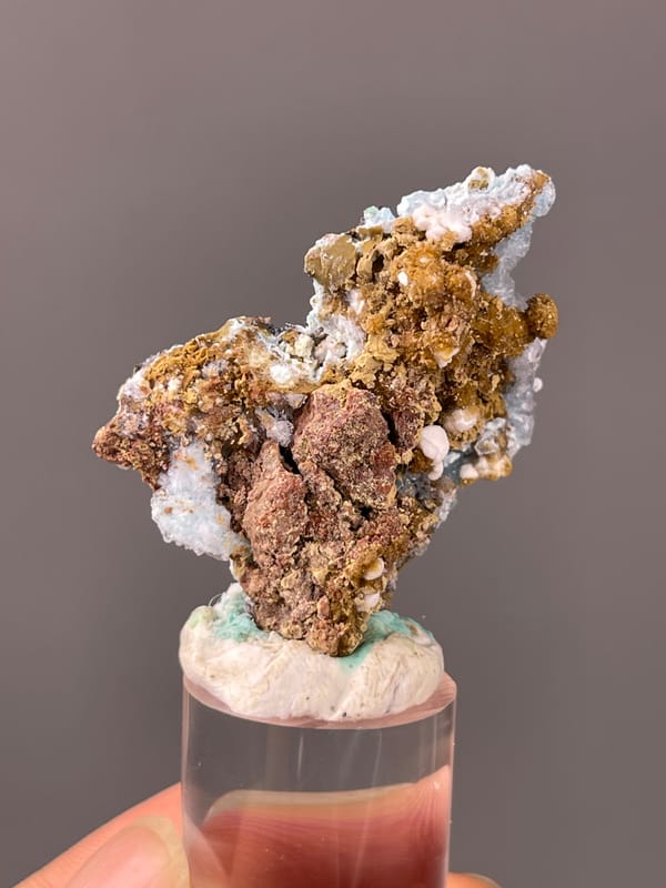 Gibbsite specimen from Qinglong, Guizhou, China featuring pale blue botryoidal crust on brown matrix