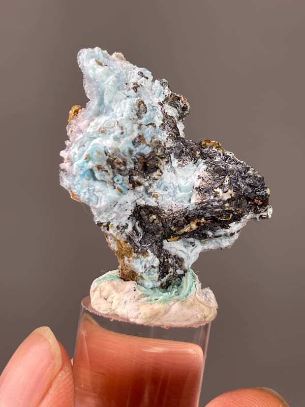 Gibbsite specimen from Qinglong, Guizhou, China showing pale blue botryoidal crust on brown matrix