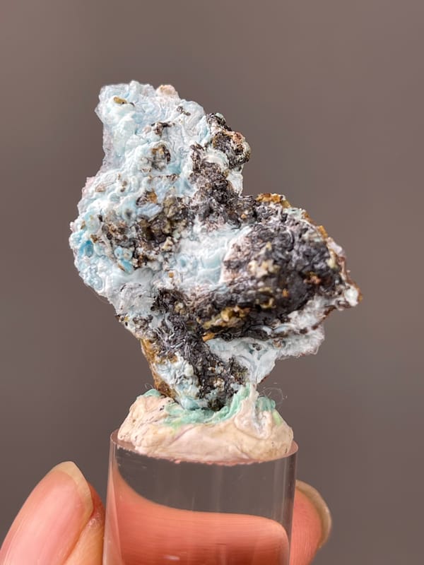 Gibbsite specimen from Qinglong, Guizhou, China presenting pale blue botryoidal crust on brown matrix