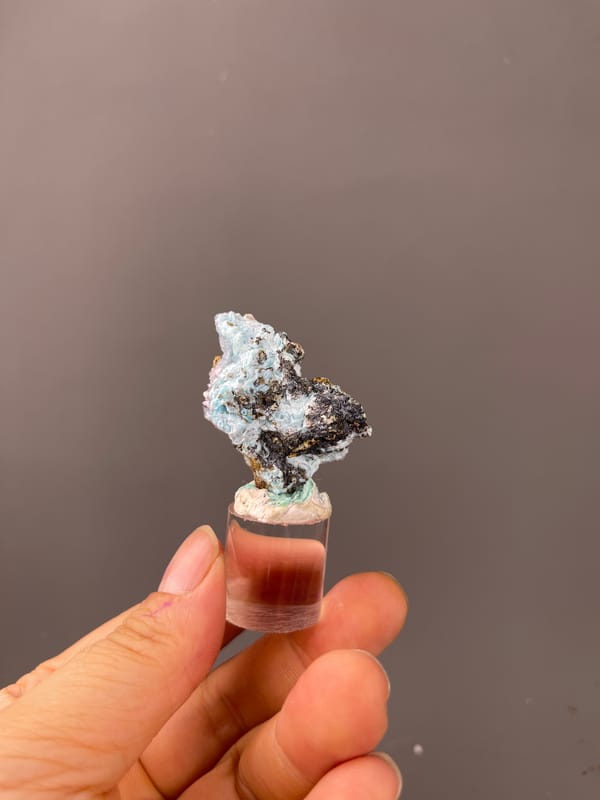 Gibbsite specimen from Qinglong, Guizhou, China displaying pale blue botryoidal crust on brown matrix