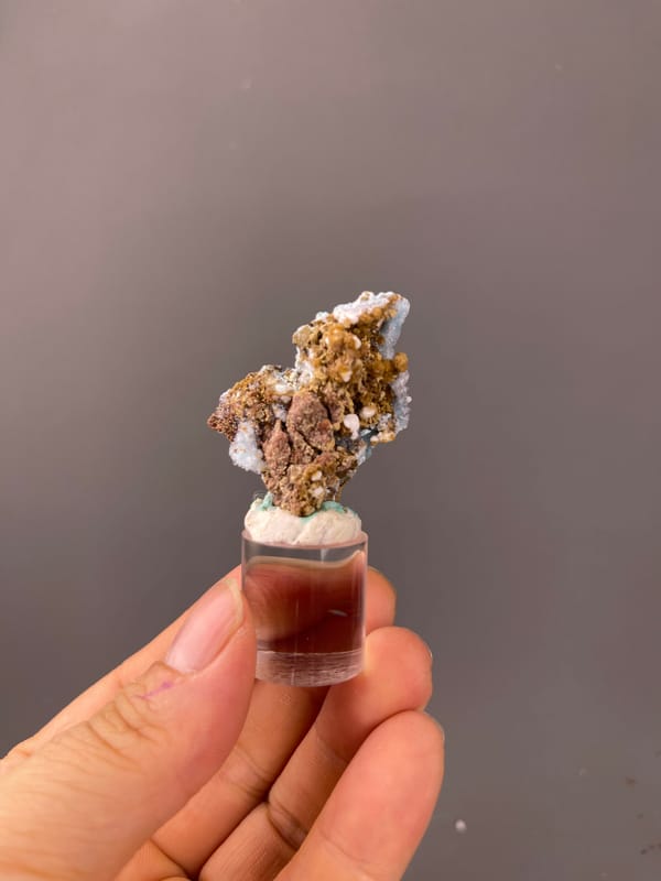 Pale blue botryoidal crust on brown matrix on natural gibbsite specimen from Qinglong, Guizhou, China
