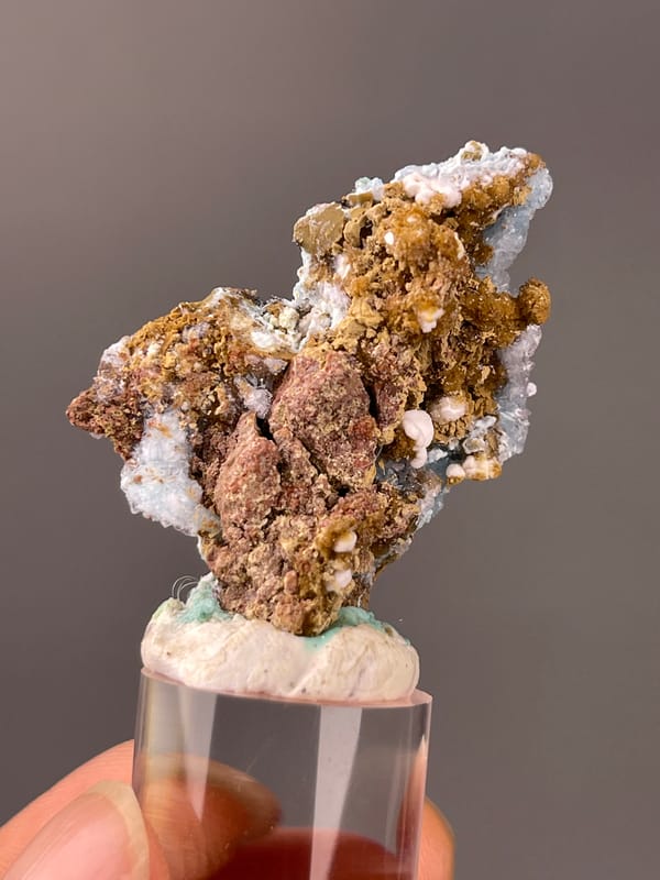 Gibbsite specimen from Qinglong, Guizhou, China highlighting pale blue botryoidal crust on brown matrix