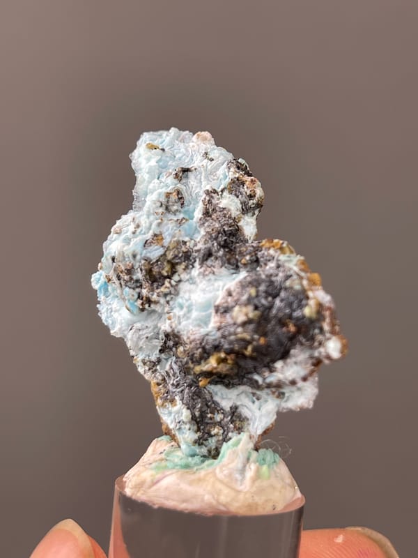 Gibbsite specimen from Qinglong, Guizhou, China, detailed with pale blue botryoidal crust on brown matrix
