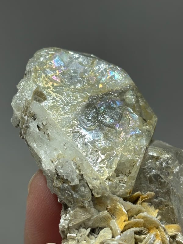 Glassy aquamarine with iridescent faces and mica from Xuebaoding, Sichuan, China