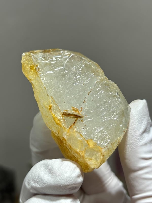Glassy pale aquamarine wedge with golden inclusions from Xuebaoding, Sichuan, China