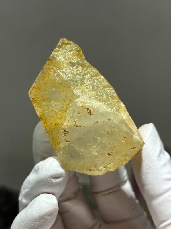 Glassy pale aquamarine wedge with golden inclusions from Xuebaoding, Sichuan, China, view 2 of 6
