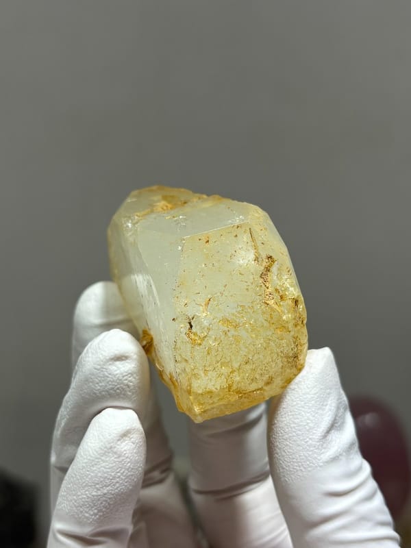 Glassy pale aquamarine wedge with golden inclusions from Xuebaoding, Sichuan, China, view 3 of 6