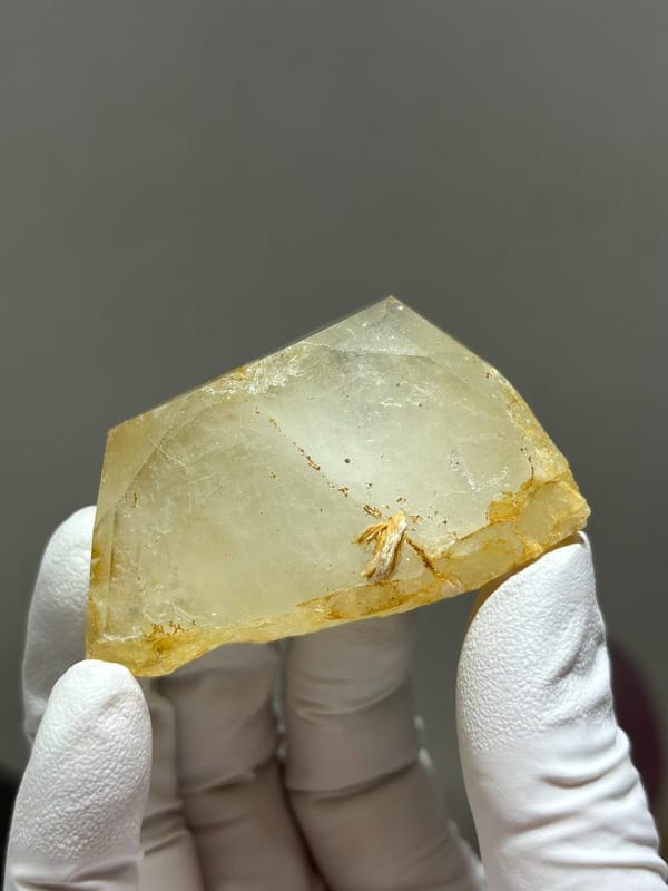 Glassy pale aquamarine wedge with golden inclusions from Xuebaoding, Sichuan, China, view 4 of 6