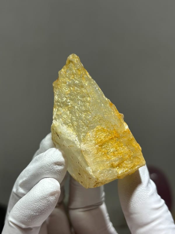 Glassy pale aquamarine wedge with golden inclusions from Xuebaoding, Sichuan, China, view 5 of 6