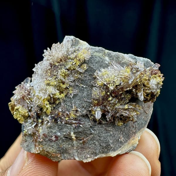 Glittering creedite flakes on grey rock from Guizhou, China