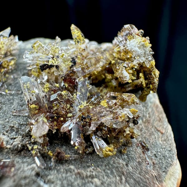 Glittering creedite flakes on grey rock from Guizhou, China, view 2 of 6