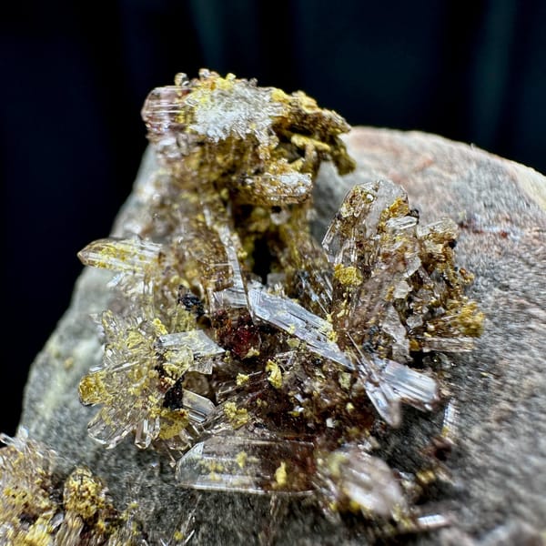 Glittering creedite flakes on grey rock from Guizhou, China, view 5 of 6