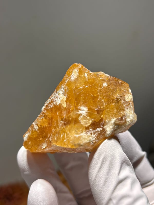 Golden scheelite with mica from Xuebaoding, Sichuan, China, close-up of the crystal faces