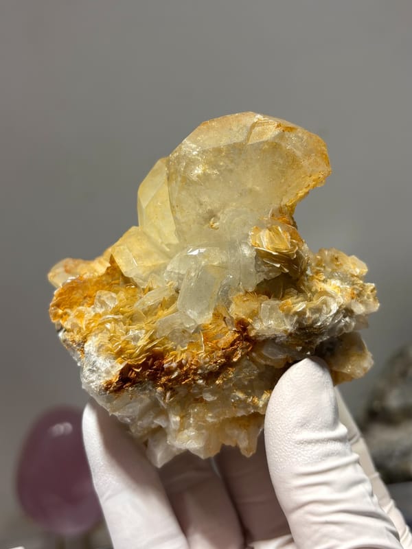 Golden-tinted aquamarine cluster with mica from Xuebaoding, Sichuan, China, close-up of the crystal faces