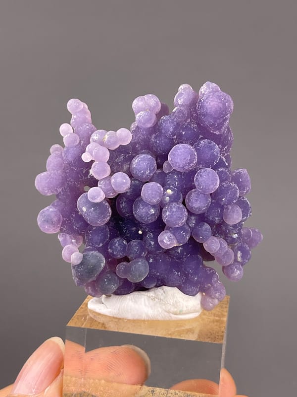 Grape Agate from Indonesia: dense purple nodules with a branching upper edge.