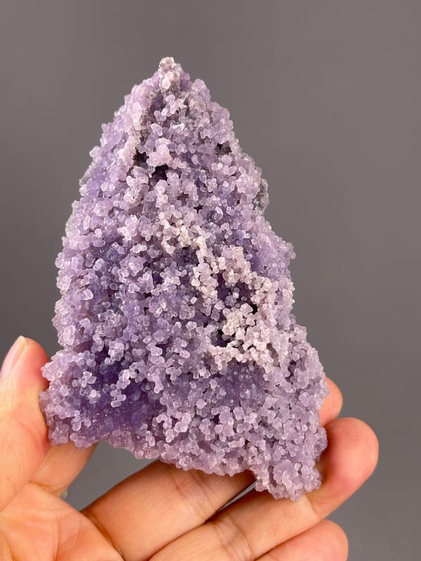 Grape Agate from Indonesia: tapering outline covered in purple nodules.
