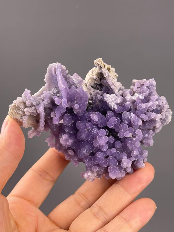 Grape Agate from Indonesia: reverse profile with exposed pale matrix.
