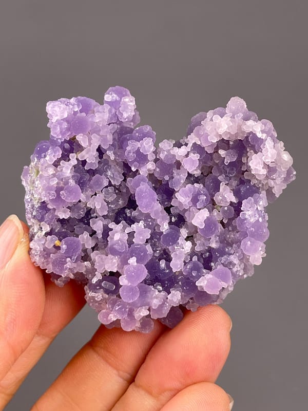 Grape Agate from Indonesia: pale rounded growths around dark purple recesses.