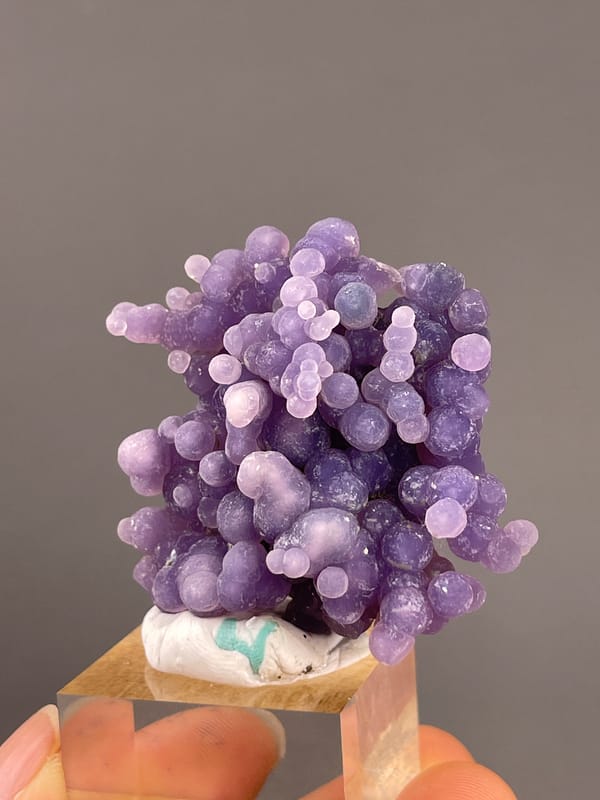 Grape Agate from Indonesia: small pale spheres among larger violet lobes.