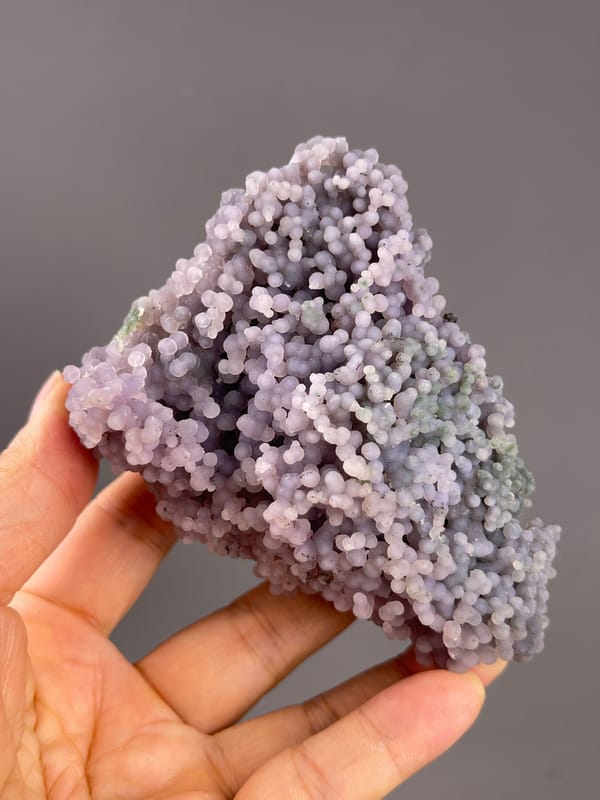 Grape Agate from Indonesia: rounded underside with pale greenish patches.