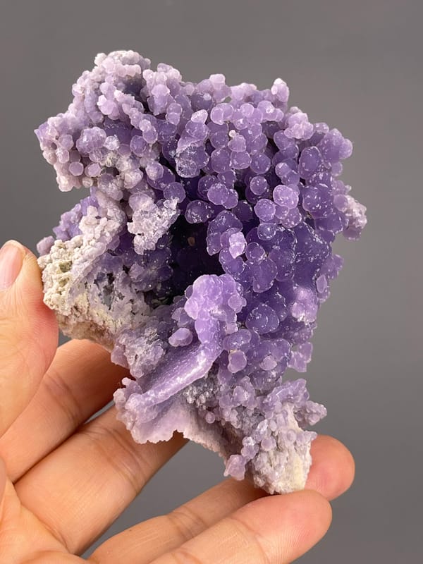 Grape Agate from Indonesia: hollow beneath large purple growths.