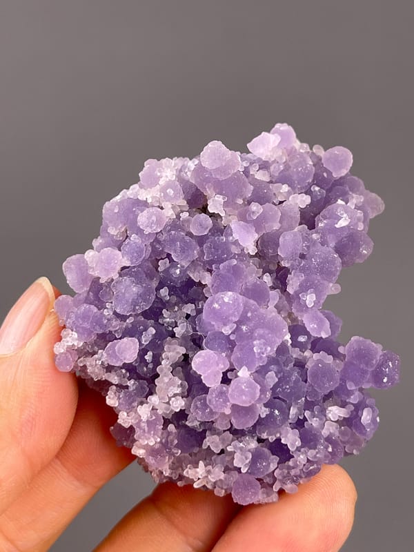 Grape Agate from Indonesia: tilted view of the broad purple clustered face.