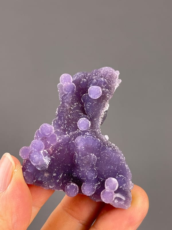 Grape Agate from Indonesia: wider lower profile with rounded violet growths.