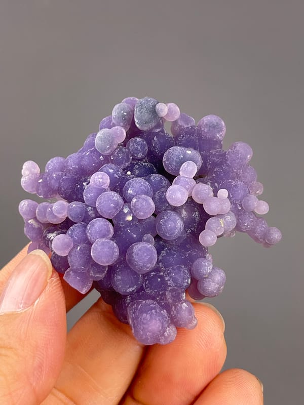 Grape Agate from Indonesia: upper angle showing pale tips and purple spheres.