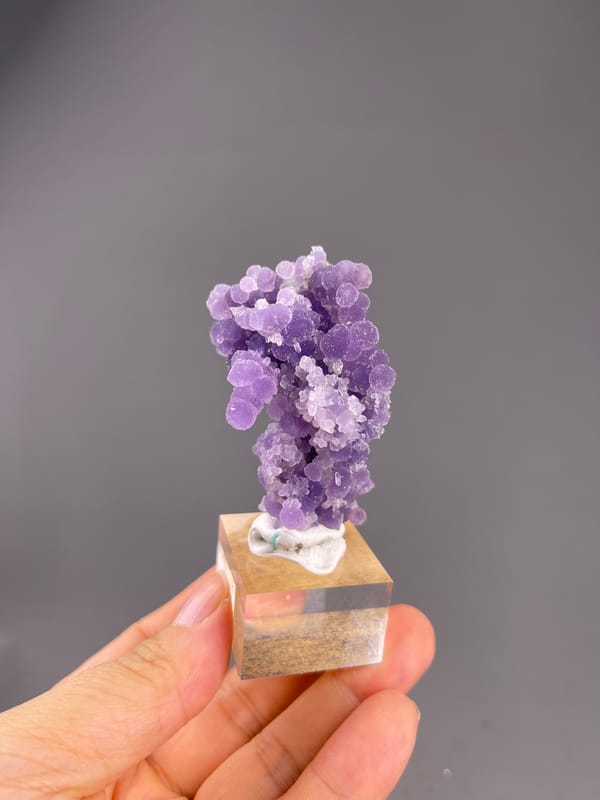 Grape Agate from Indonesia: whole upright purple grape agate on its display base.