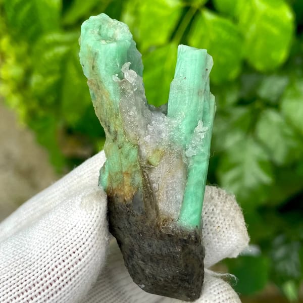 Two green emerald prisms in dark mica schist from Yunnan, China, view 9 of 9
