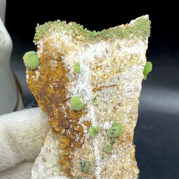 Green pyromorphite balls on tall rusty plate from Guangxi, China, view 2 of 9