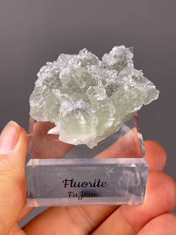Green Fluorite on Quartz specimen from Fujian, China featuring pale green fluorite cubes on clear quartz