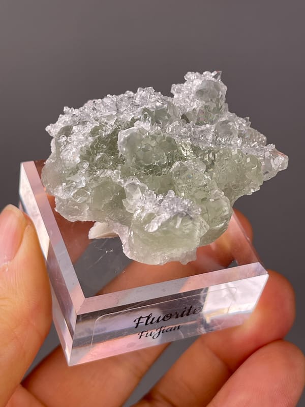 Green Fluorite on Quartz specimen from Fujian, China showing pale green fluorite cubes on clear quartz