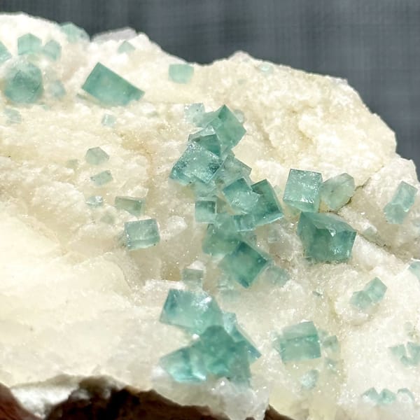Glassy sea-green fluorite cubes on cream quartz from Madagascar, view 3 of 11