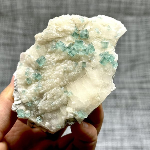Glassy sea-green fluorite cubes on cream quartz from Madagascar, view 6 of 11