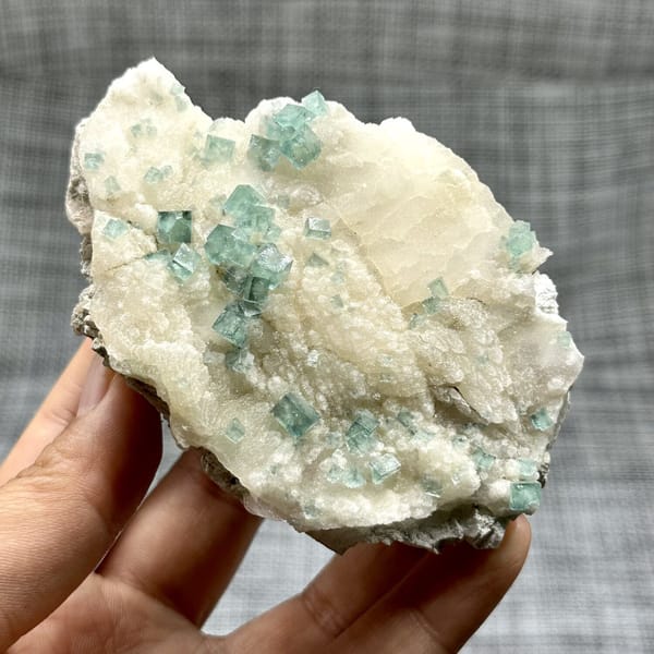 Glassy sea-green fluorite cubes on cream quartz from Madagascar, view 7 of 11