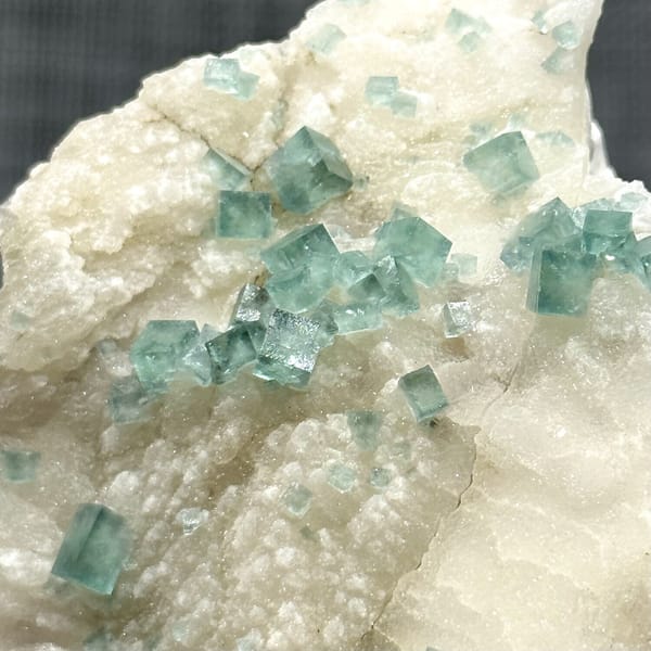 Glassy sea-green fluorite cubes on cream quartz from Madagascar, view 11 of 11