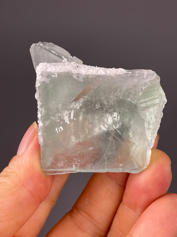Pale green cube with frosted edge on natural green fluorite specimen from Zhejiang, China