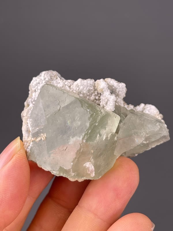 Green Fluorite specimen from Fujian, China bearing pale green fluorite and white microcrystals