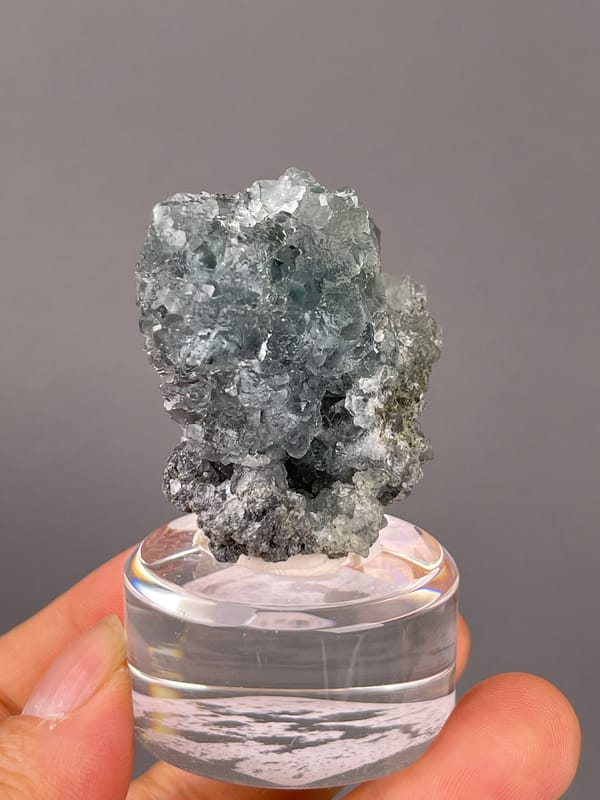 Pale blue-gray octahedral cluster visible on green octahedral fluorite specimen from Fujian, China