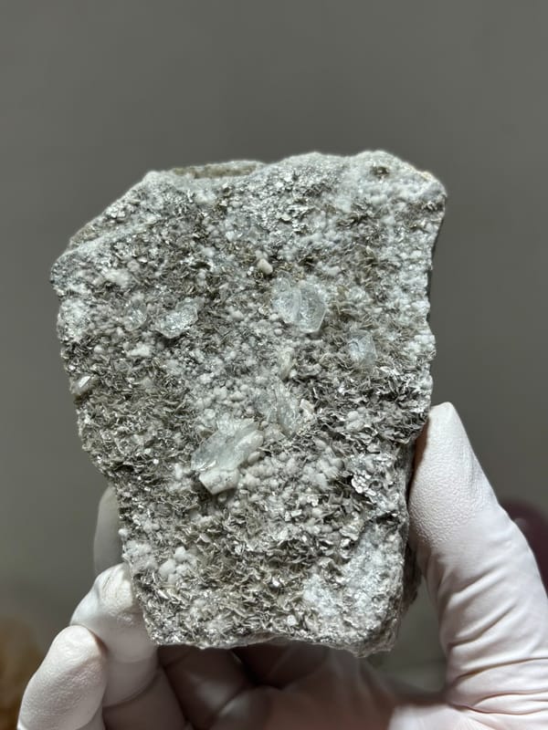 Grey matrix block dotted with pale aquamarine crystals from Xuebaoding, Sichuan, China, second angle