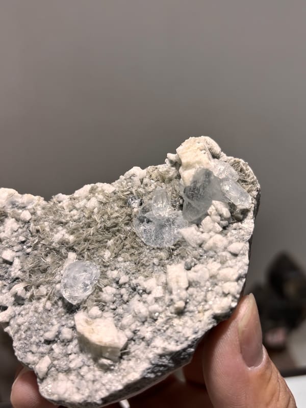 Grey matrix plate with pale aquamarine from Xuebaoding, Sichuan, China, close-up of the crystal faces