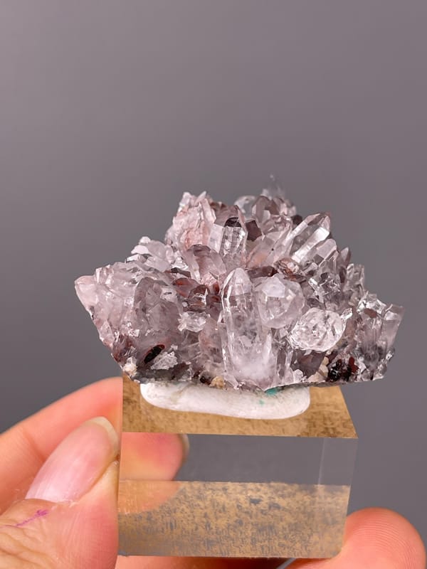 Hematite-Included Quartz specimen from Longyan, Fujian, China showing mauve quartz prisms with red inclusions