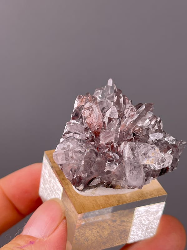 Hematite-Included Quartz specimen from Longyan, Fujian, China, defined by mauve quartz prisms with red inclusions