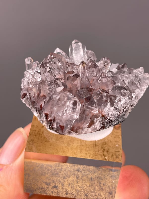 Hematite-Included Quartz specimen from Longyan, Fujian, China displaying mauve quartz prisms with red inclusions